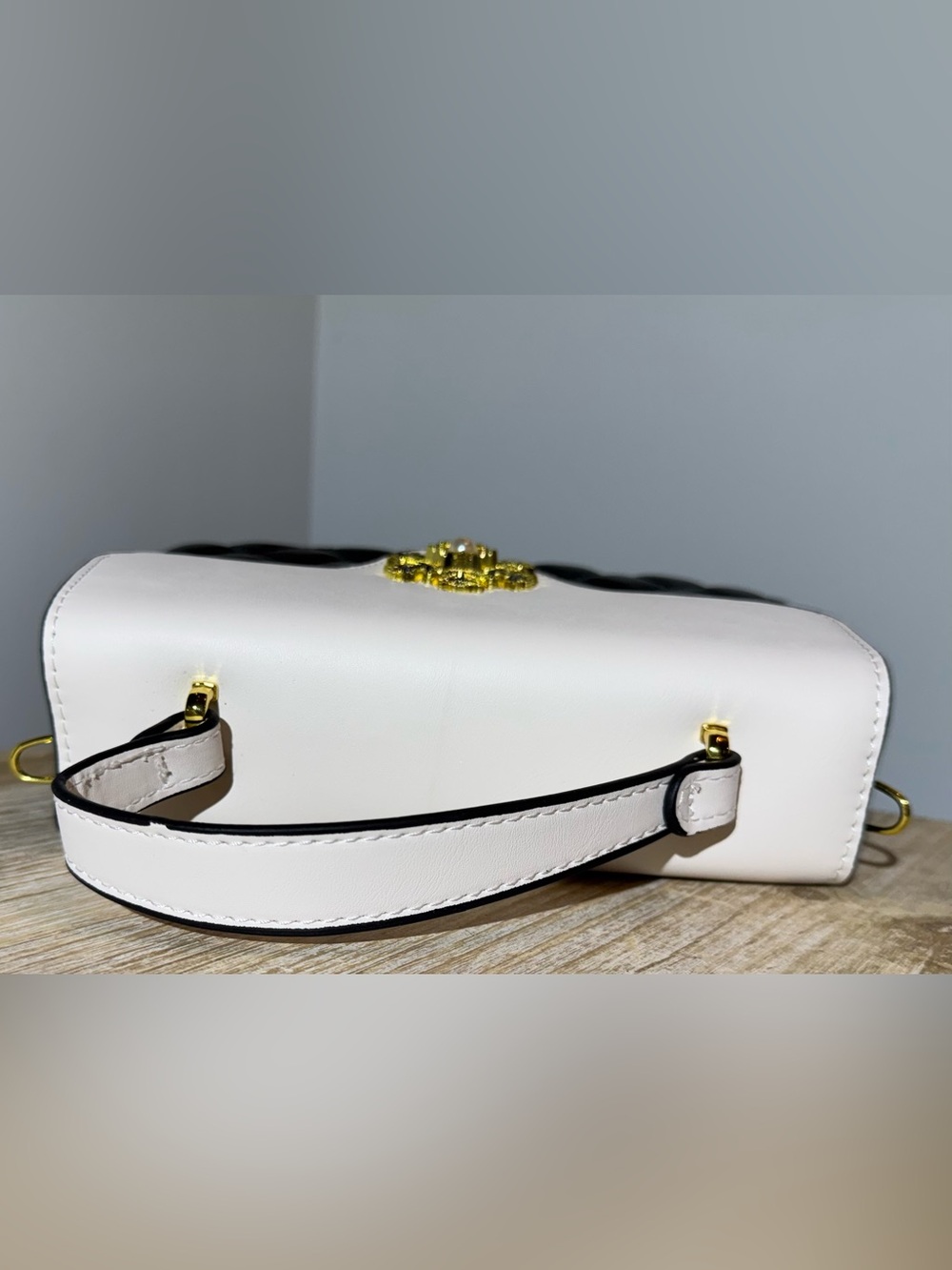 White and Black Quilted Top-Handle Bag with Gold Emblem - Picture 5 of 11